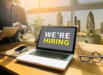The phrase We're hiring written on a laptop screen - Coren Law Group P.C.