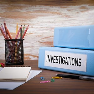 A desk with a file box, pencils, and a notepad - Coren Law Group P.C.